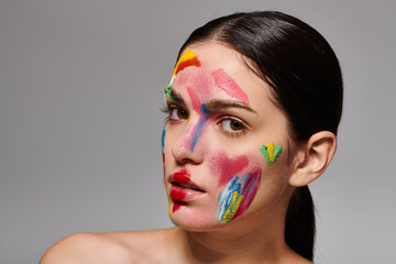 Young beautiful woman showcases vibrant face art in a striking and colorful expression