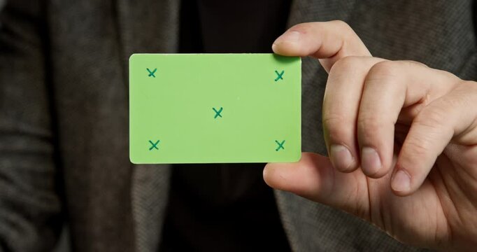 Man in the jacket holds a credit card template, which is ideal for creating layouts, digital payments, and finance-related projects. Without a corporate identity, it is perfect for creating customizab