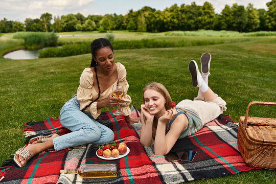 Joyful moments shared between a beautiful lesbian couple during a sunny picnic in the park - Powered by Adobe