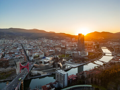 Bilbao cityscape with Guggenheim Museum, Nervión river and Iberdrola tower at sunset