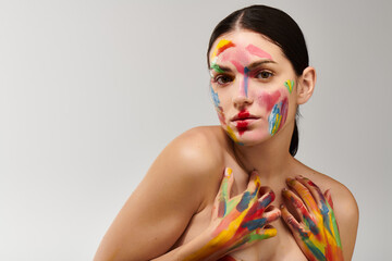 Vibrant face art highlights beauty of young woman in creative artistic expression