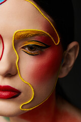 Vibrant face art showcased by a young beautiful woman in an artistic makeup display