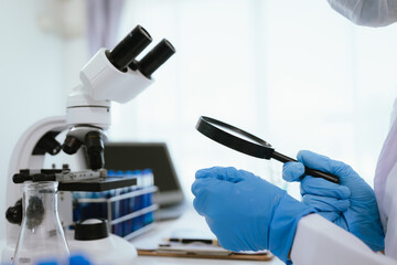 Scientist analyzes biological samples using advanced laboratory equipment for medical research, diagnosis, biotechnology development, and pharmaceutical or clinical discoveries.