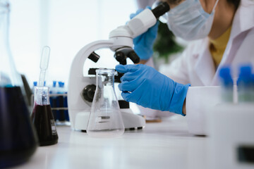 Scientist analyzes biological samples using advanced laboratory equipment for medical research, diagnosis, biotechnology development, and pharmaceutical or clinical discoveries.