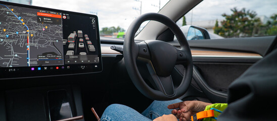 Woman drive electric car with auto pilot steering system technology
