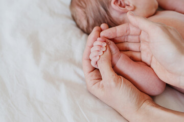 Close-up little hand of child baby holding hand of mother.