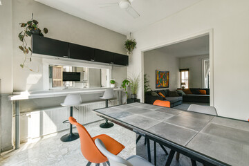 Bright and open space featuring contemporary furniture and plants, showcasing a stylish dining area...