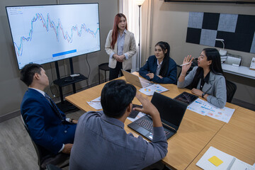 Business team discusses financial data during meeting in modern office space