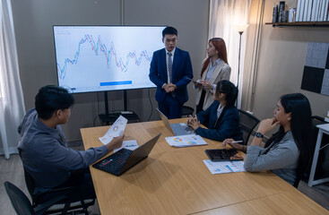 Group of professionals discussing business strategies and data analytics in a modern conference room