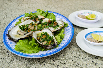 Grilled Oysters with Green Onions on Lettuce