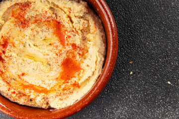 Hummus chickpea dip spices tasty appetizer vegetable dish fresh delicious gourmet vegetarian and vegan food background on the table rustic food top view copy space keto and paleo diet