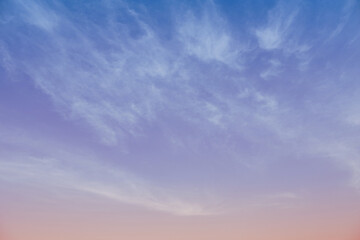 Early morning golden light over blue sky background. Aesthetic cloudscape in pastel tone color light for background or wallpaper.