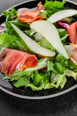 Salad pear ham vegetable dish fresh tasty gourmet food background on the table rustic food top view copy space