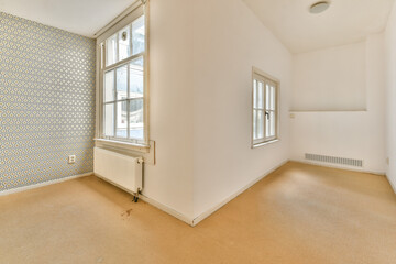 A bright and stylish interior featuring a textured wall and large windows that invite natural light. The clean lines and minimal decor create a serene ambiance.