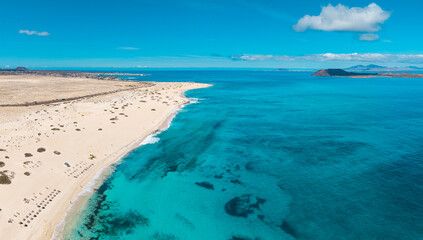 High quality aerial panoramic image of the beautiful Flag Beach, Grandes Playas with Lobos island in the background near Corralejo in Fuerteventura Spain