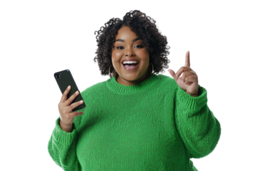 Excited woman in green sweater holding smartphone vertically and pointing, isolated on white background, ideal for technology, lifestyle, or joyful moments.

