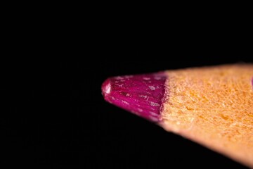 Colouring pencils on black background, colour motion
