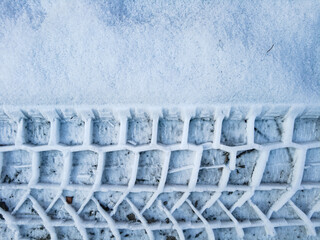 Tire tread prints on the ground. tire tracks. Tire tracks on a sandy road. Car tread prints on the sand. Footprint and traces of an off-road car tires in the mud. tire prints in the snow. © Taras