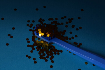 Toothbrush with sparkles on a dark blue background, concepts of dentistry and hygiene. Oral health.