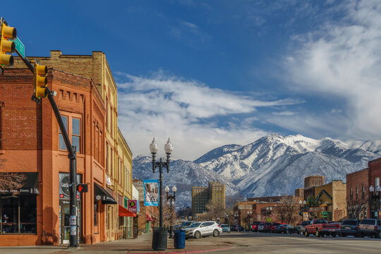 Ogden, UT, US-January 29, 2016: Colorful downtown of this Utah city with quaint brick buildings and scenic snow-capped mountains in background.