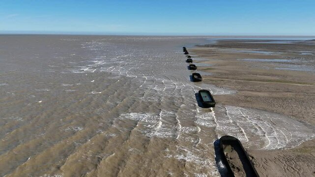 Row of Barges on River Blackwater Essex UK used for WW2 target practice