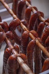Pork sausages are being dried after smoking.