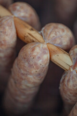 Homemade Polish style pork sausages are being smoked.