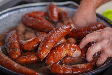 Pork sausages are being rinsed after steaming.