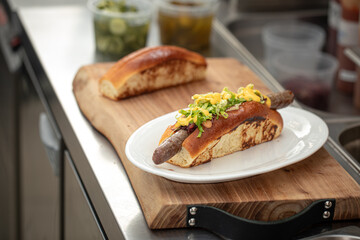 Preparing appetizing hot dogs in american diner kitchen counter