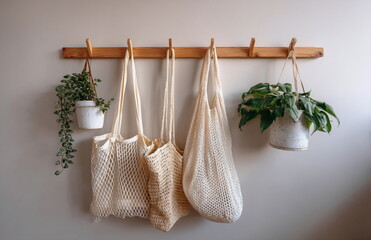 Hanging cotton mesh produce bags on wall hooks, promoting eco-friendly shopping and plastic-free kitchen storage.
