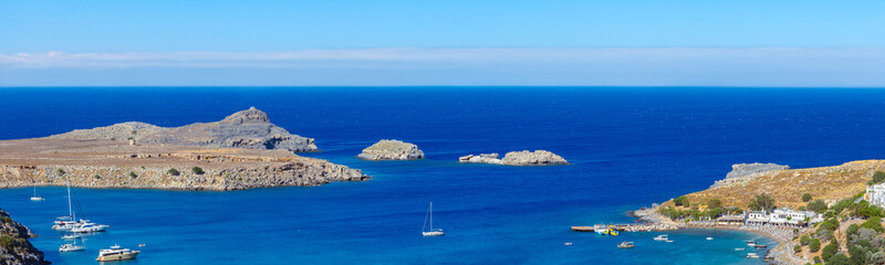 Lindos, with its ancient acropolis, ruins fortress and closed bays in sea coast, is the most view place of Rhodes island in Dodecanese, Greece. Vacation on Greece islands in Mediterranean sea. © Sodel Vladyslav