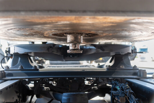 Close-up of a trailer kingpin and fifth wheel coupling