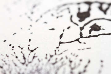 Extreme close up of black acrylic paint texture on paper. Selective focus.