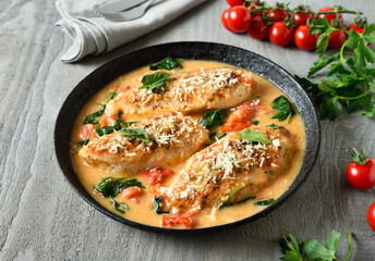 Chicken breast in creamy sauce with tomatoes and spinach