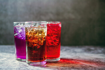 A lot of Soft drinks in colorful and flavorful glasses on the table,Glasses with sweet drinks with ice cubesv