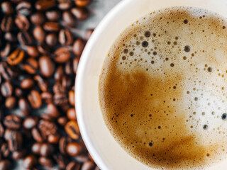 Coffee crema espresso in paper Coffee cup and bean, close-up, Top view of Espresso in  Takeaway paper coffee cup