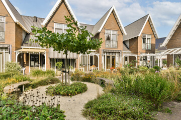 A picturesque residential area featuring modern homes surrounded by vibrant greenery and beautifully landscaped gardens, creating a serene community vibe.