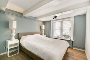 A beautifully designed modern bedroom featuring soft colors and minimalistic decor, creating a serene and inviting atmosphere perfect for relaxation.