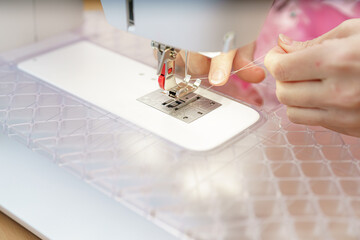 Sewing machine in use demonstrating fine crafting of fabric at a daytime workshop