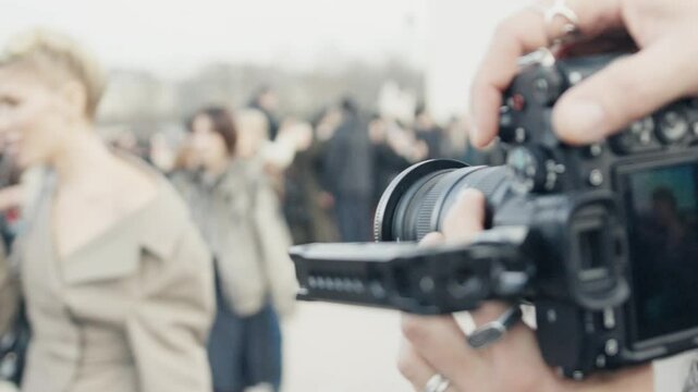 Paparazzi photographing celebrity during fashion week