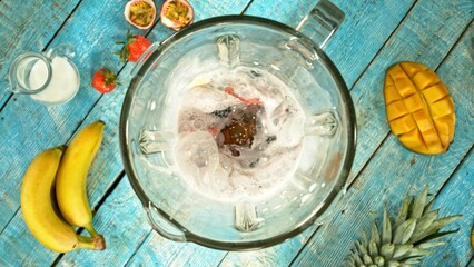 Fresh smoothie drink. Preparing smoothie in a blender. Mix of fruit and vegetable with milk.