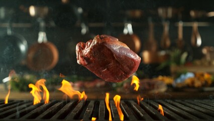 Beef Raw Steak falling on Grill with Fire. Preparation of Fresh Steak in Kitchen.