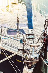 Sailboat deck with focus on rigging and sunlight reflection, background