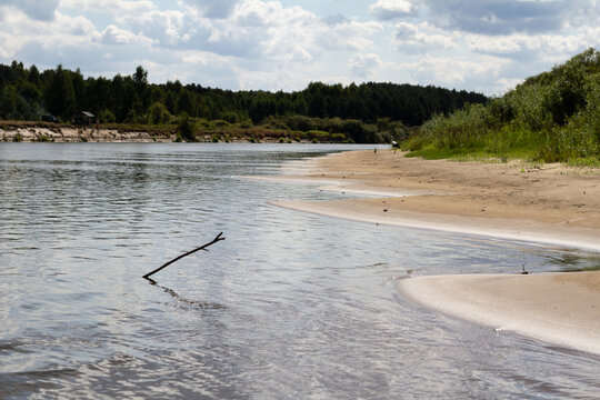 A scenic view of the Sozh River flowing through the Belarusian countryside, surrounded by calm nature.
