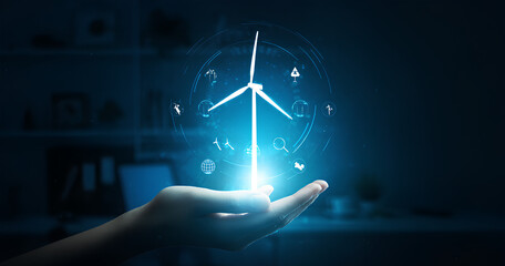 Hand holding a digital wind turbine, showcasing sustainable energy.
