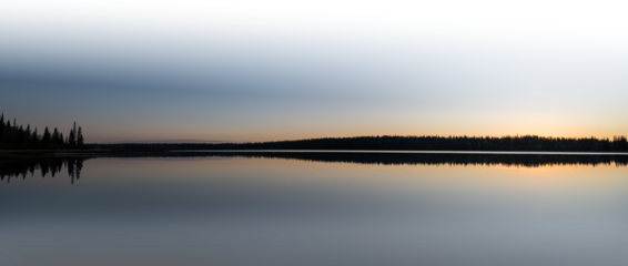 Panorama of large clam lake at sunset with partially transparent sky and water
