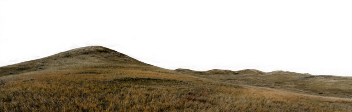 Panorama of rolling hills and autumn colored prairie grass with a transparent sky