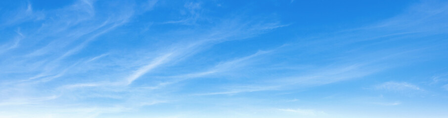 clear blue sky with clouds. very bright and the sun is shining