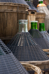 Traditional glass wine bottles with protective wicker baskets preserving wine heritage
