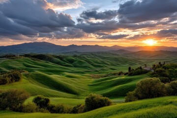 Obraz premium Rolling green Tuscan hills at sunset, mountains background. Travel stock photo